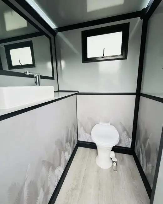 Restroom trailer stall with vessel sink